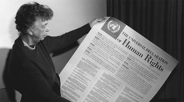 Universal-Declaration-of-Human-Rights.jpg  Eleanor Roosevelt holding poster of the Universal Declaration of Human Rights (in English), Lake Success, New York. November 1949.  FDR Presidential Library & Museum